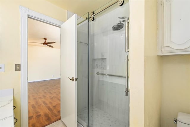 410 NW Taylor Ave, Piedmont, OK 73078 - full bathroom featuring a shower stall, toilet, a ceiling fan, and wood finished floors