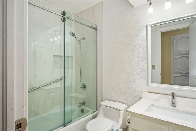 410 NW Taylor Ave, Piedmont, OK 73078 - bathroom with a textured wall, toilet, bath / shower combo with glass door, and vanity