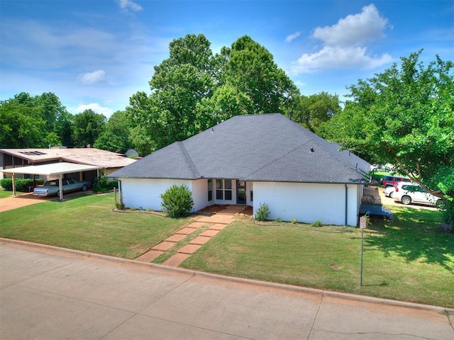 6001 Broadmoor Ave, Oklahoma City, OK 73132 - mid-century modern home featuring a front lawn, a carport, and roof with shingles