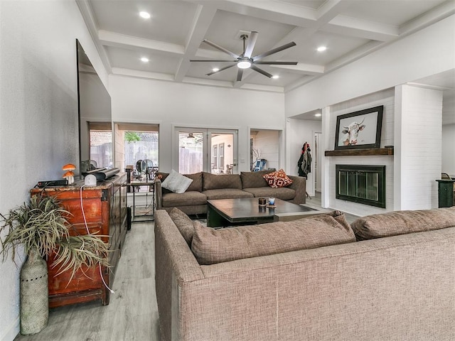 6001 Broadmoor Ave, Oklahoma City, OK 73132 - living area featuring wood finished floors, ceiling fan, coffered ceiling, a large fireplace, and beamed ceiling