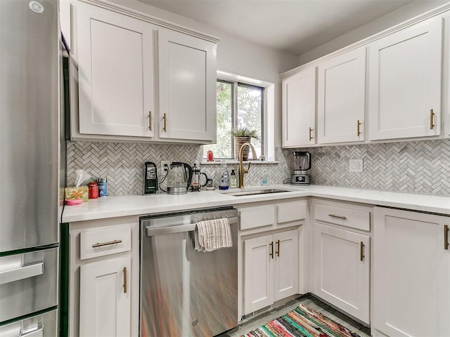6001 Broadmoor Ave, Oklahoma City, OK 73132 - kitchen featuring stainless steel appliances, a sink, decorative backsplash, and white cabinetry