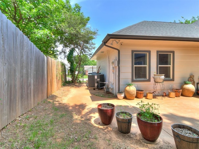 6001 Broadmoor Ave, Oklahoma City, OK 73132 - fenced backyard with cooling unit and a patio area