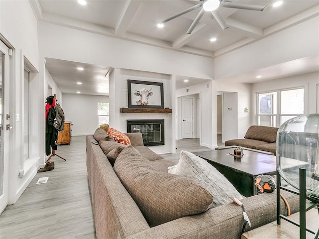 6001 Broadmoor Ave, Oklahoma City, OK 73132 - living room with a ceiling fan, coffered ceiling, beamed ceiling, a fireplace, and light wood-style floors