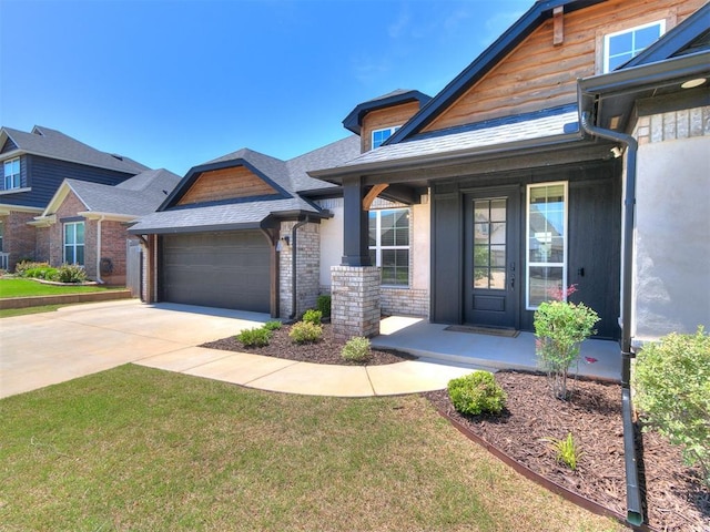 222 Alamosa Rd, Norman, OK 73069 - view of front of property featuring an attached garage, concrete driveway, a front yard, and a porch