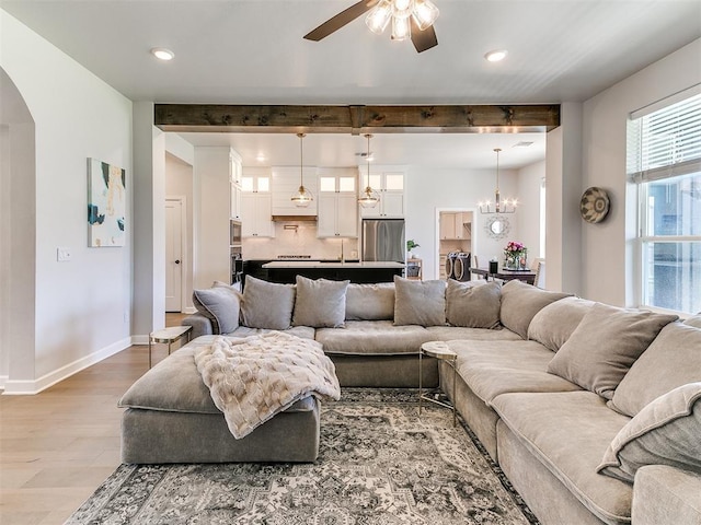 222 Alamosa Rd, Norman, OK 73069 - living area with arched walkways, wood finished floors, a ceiling fan, baseboards, and a chandelier