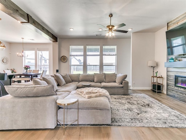 222 Alamosa Rd, Norman, OK 73069 - living area featuring wood finished floors, recessed lighting, a ceiling fan, a stone fireplace, and a chandelier