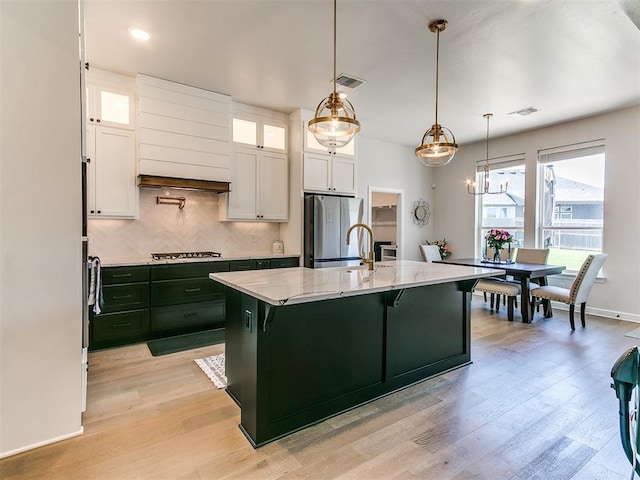 222 Alamosa Rd, Norman, OK 73069 - kitchen featuring freestanding refrigerator, white cabinets, light stone countertops, light wood-style flooring, and recessed lighting