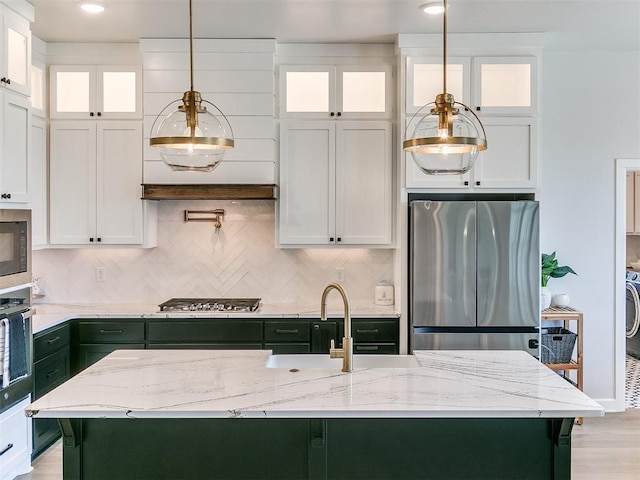 222 Alamosa Rd, Norman, OK 73069 - kitchen with appliances with stainless steel finishes, white cabinetry, decorative backsplash, and light stone countertops
