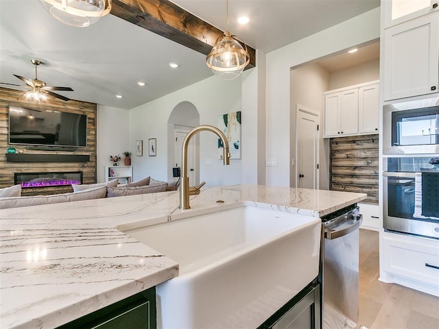 222 Alamosa Rd, Norman, OK 73069 - kitchen with stainless steel appliances, a sink, white cabinets, open floor plan, and recessed lighting