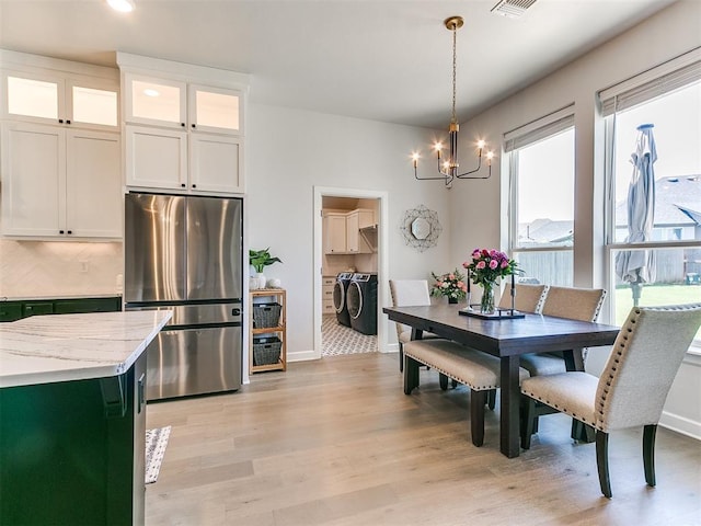 222 Alamosa Rd, Norman, OK 73069 - dining space featuring washing machine and dryer, a chandelier, light wood finished floors, baseboards, and recessed lighting