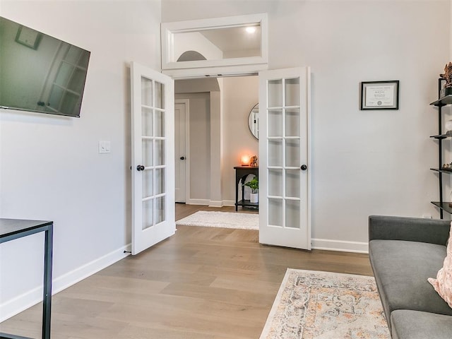 222 Alamosa Rd, Norman, OK 73069 - living area with french doors, wood finished floors, and baseboards