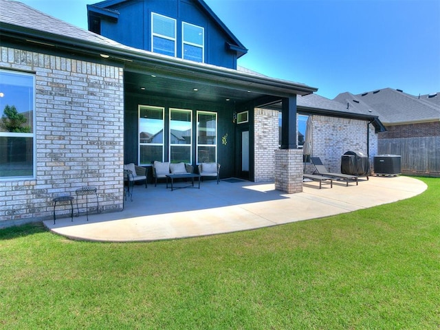 222 Alamosa Rd, Norman, OK 73069 - back of property with a patio area, cooling unit, brick siding, and an outdoor living space