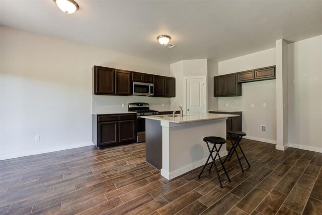 9749 Livingston Rd, Edmond, OK 73025 - kitchen with stainless steel appliances, dark wood-style flooring, light countertops, and dark brown cabinetry