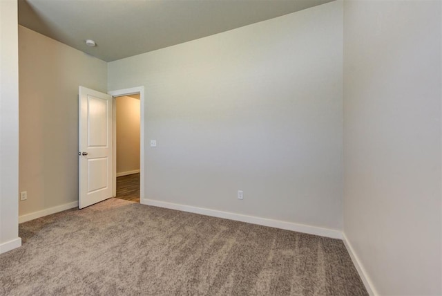 9749 Livingston Rd, Edmond, OK 73025 - spare room featuring carpet floors, baseboards, and a smoke detector