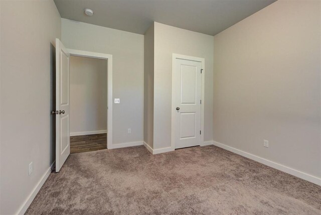9749 Livingston Rd, Edmond, OK 73025 - unfurnished bedroom featuring carpet floors and baseboards