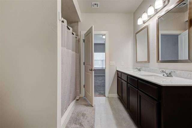 9749 Livingston Rd, Edmond, OK 73025 - full bathroom with double vanity, tile patterned floors, and baseboards