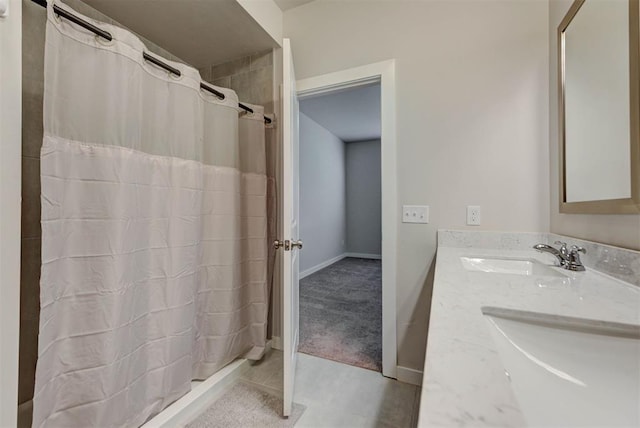 9749 Livingston Rd, Edmond, OK 73025 - full bath with double vanity, baseboards, curtained shower, and tile patterned floors