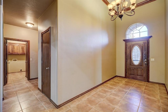 924 Regal Rd, Yukon, OK 73099 - entryway featuring a chandelier, light tile patterned floors, and baseboards