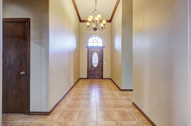 924 Regal Rd, Yukon, OK 73099 - foyer entrance with crown molding, a chandelier, baseboards, and light tile patterned flooring