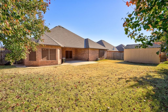 924 Regal Rd, Yukon, OK 73099 - back of property featuring brick siding, a patio, and a shingled roof