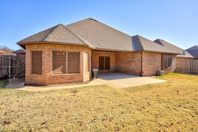 924 Regal Rd, Yukon, OK 73099 - back of property with roof with shingles, brick siding, and a patio