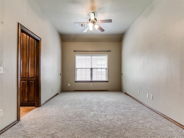 924 Regal Rd, Yukon, OK 73099 - empty room featuring a ceiling fan, light colored carpet, and baseboards