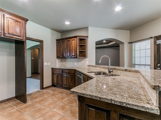 924 Regal Rd, Yukon, OK 73099 - kitchen with arched walkways, a sink, open shelves, light stone counters, and recessed lighting