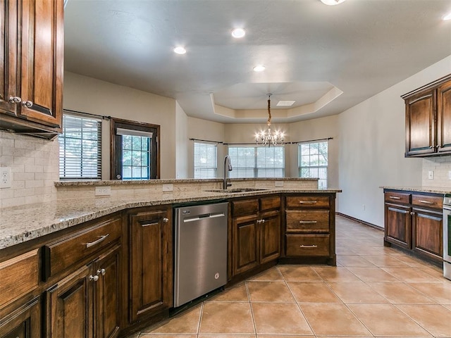 924 Regal Rd, Yukon, OK 73099 - kitchen featuring stainless steel dishwasher, a sink, tasteful backsplash, light tile patterned flooring, and a chandelier