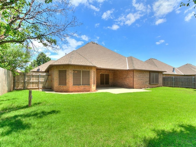 924 Regal Rd, Yukon, OK 73099 - rear view of property with brick siding, a patio, and a shingled roof