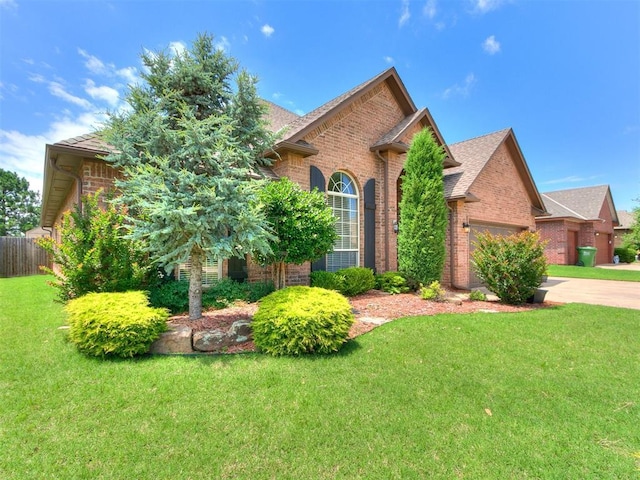 924 Regal Rd, Yukon, OK 73099 - view of front of house featuring brick siding, a garage, and driveway