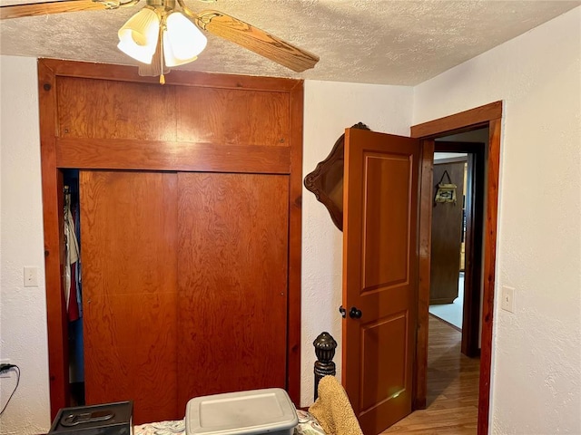 321 E Ninth St, Leedey, OK 73654 - bathroom featuring a textured ceiling, wood finished floors, ceiling fan, and a textured wall