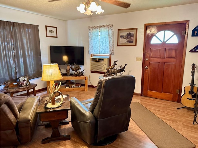 321 E Ninth St, Leedey, OK 73654 - living area with wood finished floors, a ceiling fan, cooling unit, and baseboards