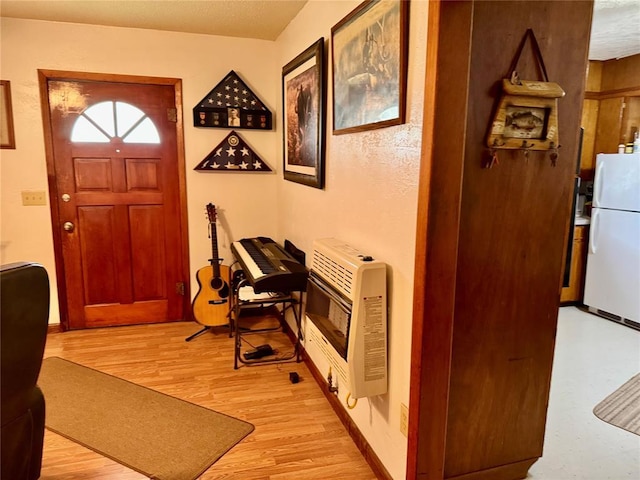 321 E Ninth St, Leedey, OK 73654 - foyer entrance featuring heating unit and light wood finished floors