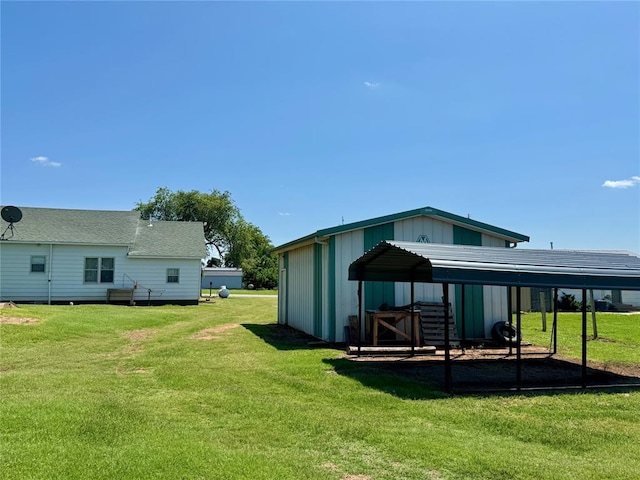321 E Ninth St, Leedey, OK 73654 - view of green lawn featuring a detached carport and an outbuilding