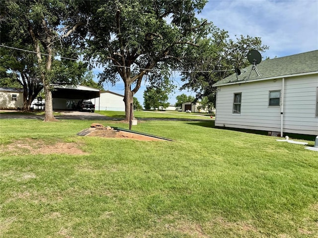 321 E Ninth St, Leedey, OK 73654 - view of green lawn with a carport