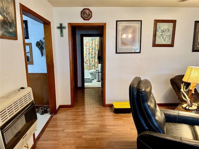 321 E Ninth St, Leedey, OK 73654 - hall featuring light wood finished floors, heating unit, and baseboards