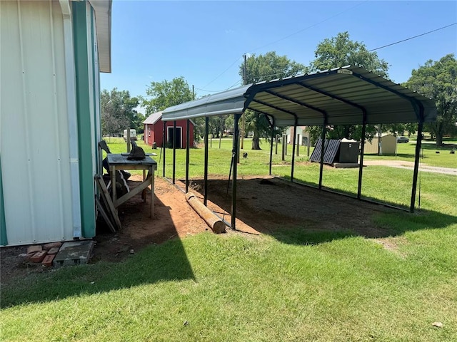 321 E Ninth St, Leedey, OK 73654 - view of green lawn featuring a carport and an outdoor structure