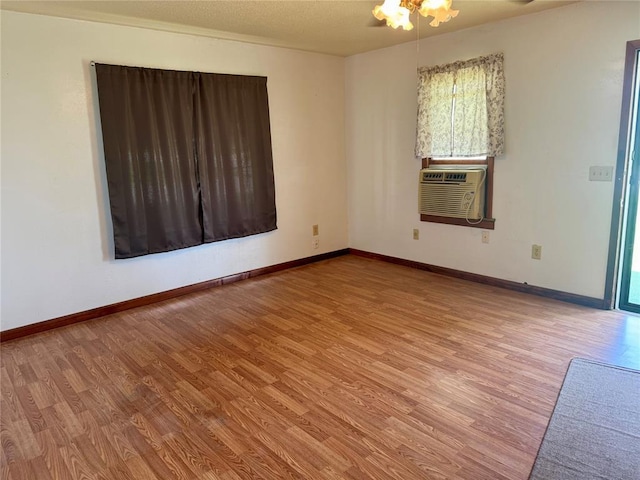 321 E Ninth St, Leedey, OK 73654 - unfurnished room featuring wood finished floors, cooling unit, and baseboards
