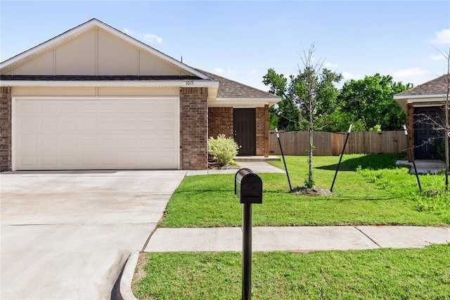 view of front facade featuring brick siding, driveway, an attached garage, and a shingled roof