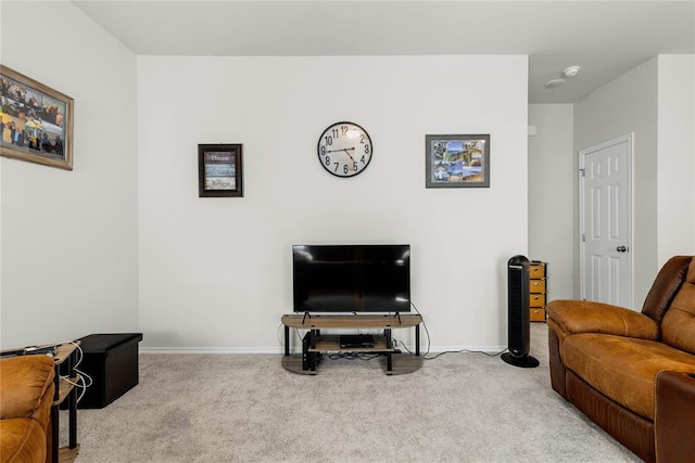 living area featuring carpet flooring and baseboards