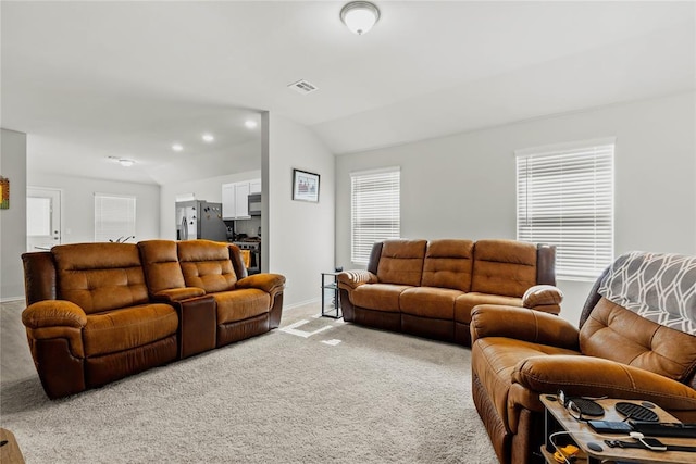 living area featuring carpet flooring, vaulted ceiling, and baseboards