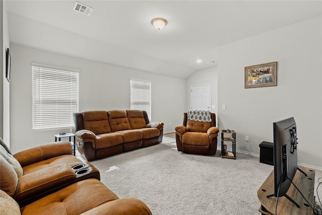 living room with carpet, lofted ceiling, and baseboards