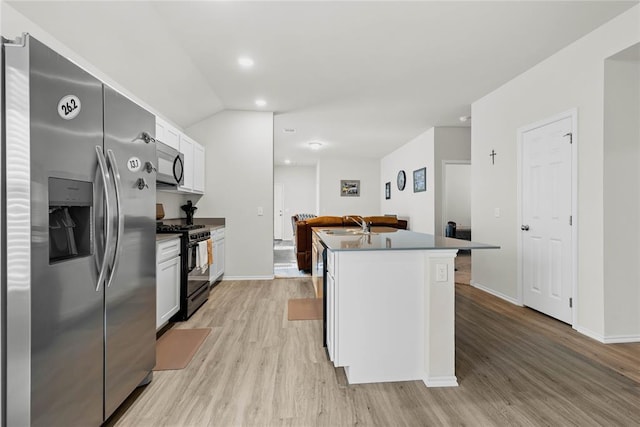 kitchen featuring black appliances, light wood-style floors, white cabinetry, and vaulted ceiling