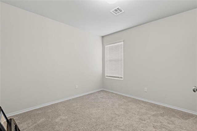 carpeted spare room with baseboards