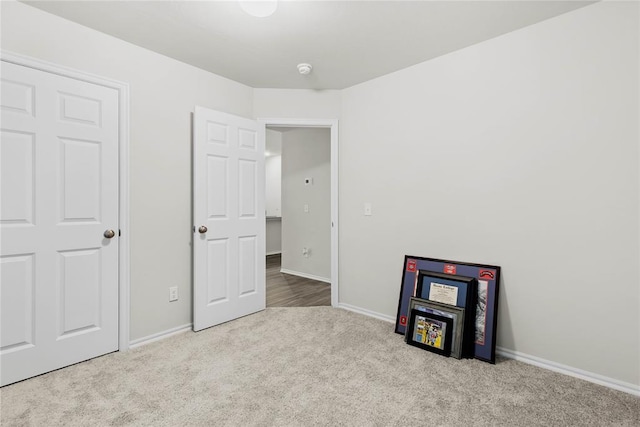 unfurnished bedroom with carpet and baseboards