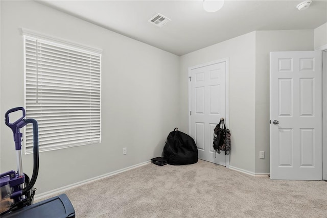 workout room with carpet and baseboards