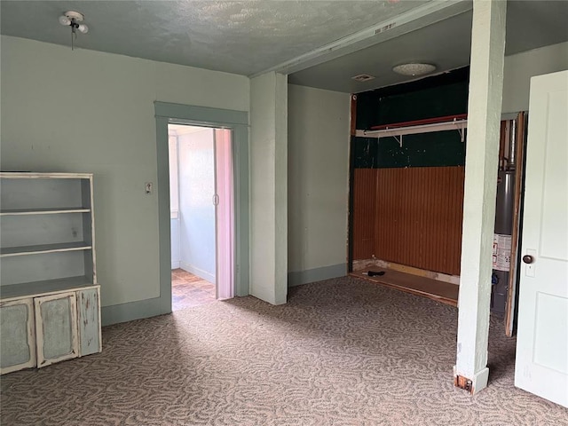711 E Walnut St, Altus, OK 73521 - unfurnished bedroom with carpet flooring, a closet, and baseboards