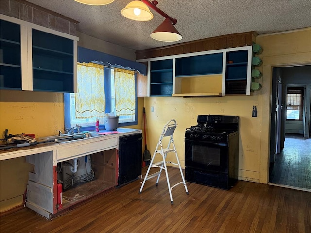 711 E Walnut St, Altus, OK 73521 - kitchen with black appliances, open shelves, a sink, hardwood / wood-style flooring, and a textured ceiling