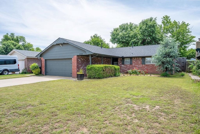 single story home with a garage, concrete driveway, brick siding, and a front lawn