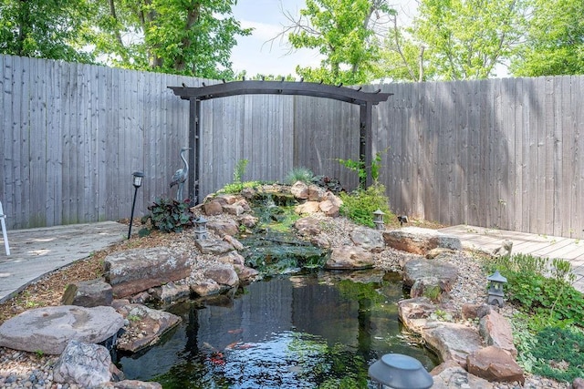 view of yard featuring a garden pond